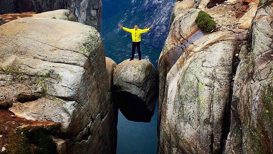 A Man Standing On Kjeragbolten 1